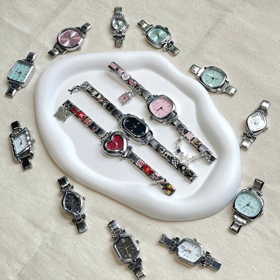 A collection of watches with various designs and colors, displayed on a white surface. 3