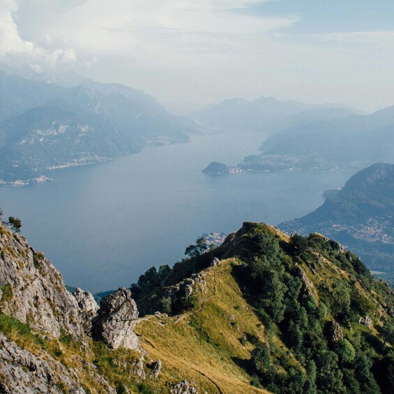 A mountainous landscape with a lake and distant islands. 2