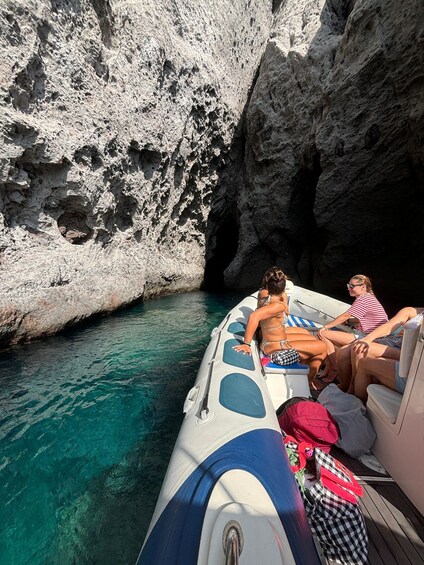 A boat navigating through a narrow waterway between rocky cliffs. 5