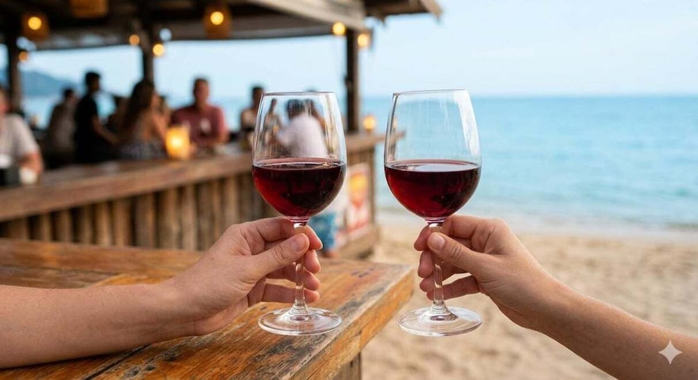 Two people toasting with wine glasses on a wooden bar by the beach. 3