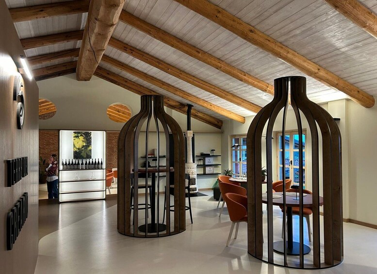 A modern interior with wooden beams, a bar area, and orange chairs. 3