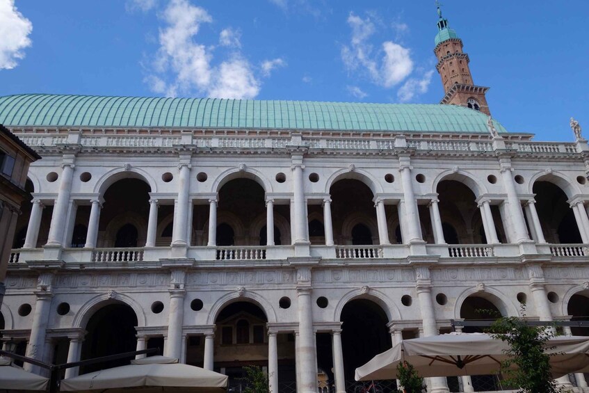 A historic building with a green dome and a clock tower. 3
