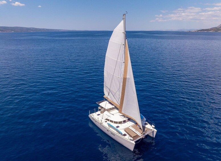 A sailboat on a calm sea with a clear sky. 3