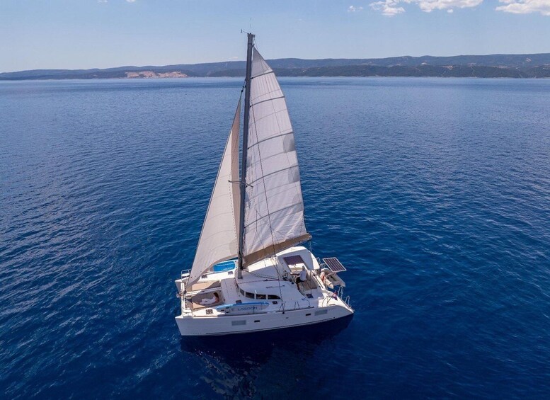 A sailboat on a calm sea with a clear sky. 2