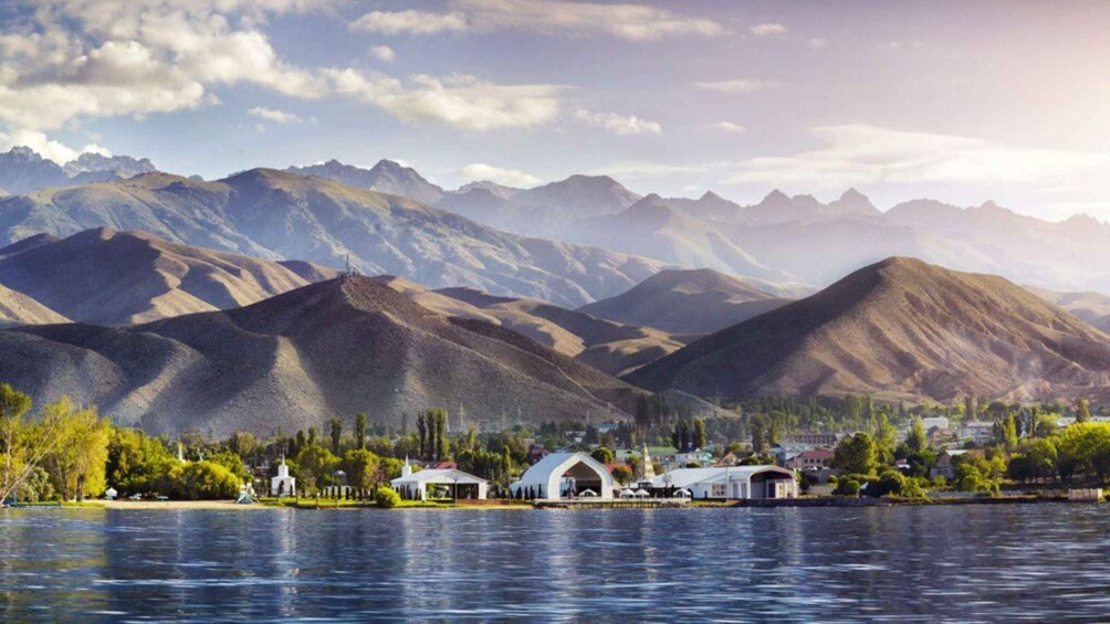 A lakeside town with mountains in the background. 3