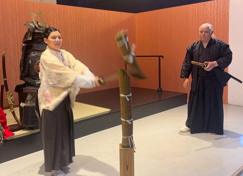 A person practicing swordsmanship with a wooden dummy in a room with traditional decor. 3