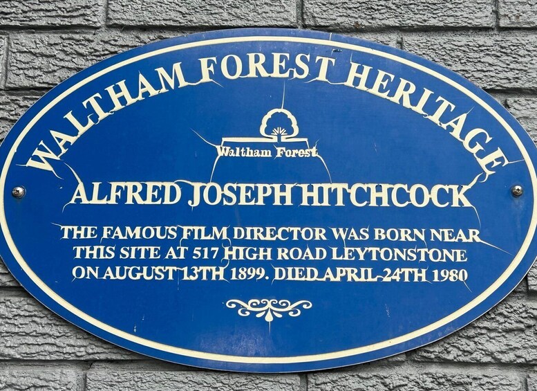 A blue plaque on a wall commemorating Alfred Joseph Hitchcock, a famous film director, with details of his birth and death. 2