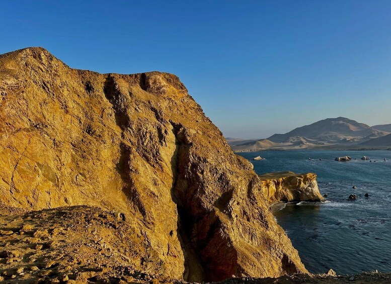 A rugged coastline with prominent cliffs and a calm sea. 4