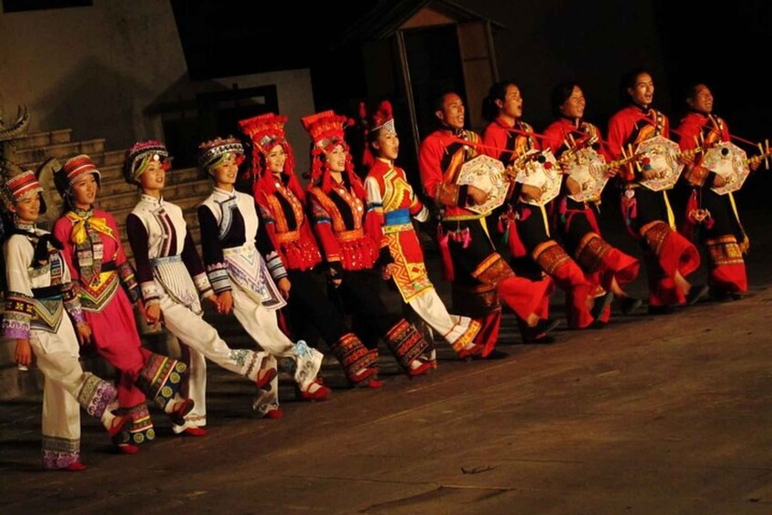 A group of people performing a traditional dance in colorful costumes. 2