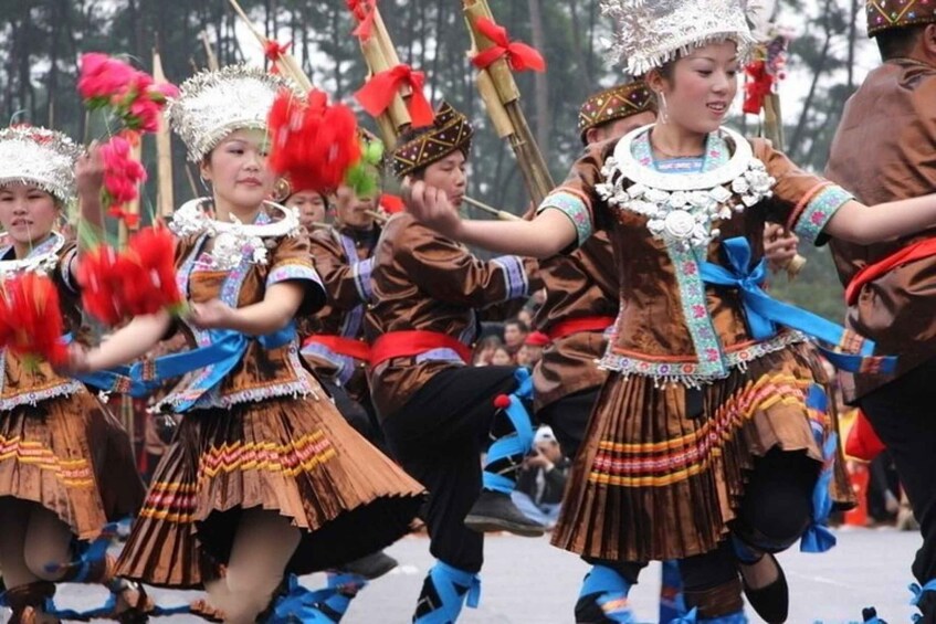 A group of people in traditional costumes performing a dance. 4
