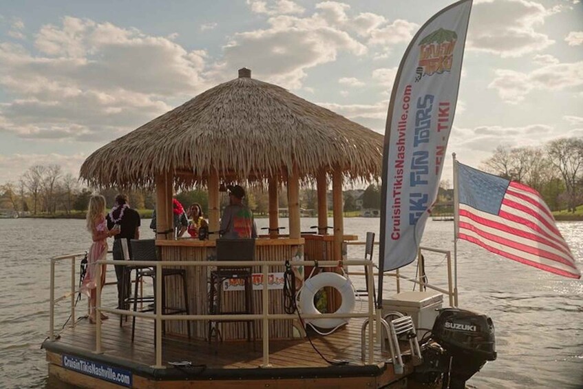 A boat with a thatched roof structure, a lifebuoy, and an American flag. 3