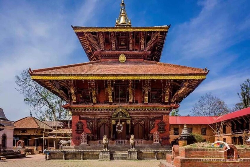 A traditional multi-tiered temple with ornate carvings and a red roof. 2