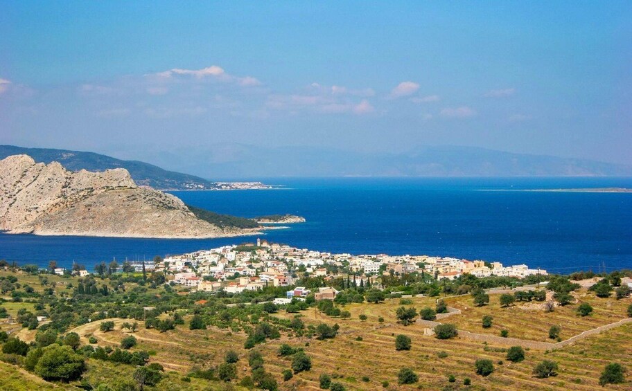 A coastal town with a mountainous backdrop and a clear view of the sea. 4