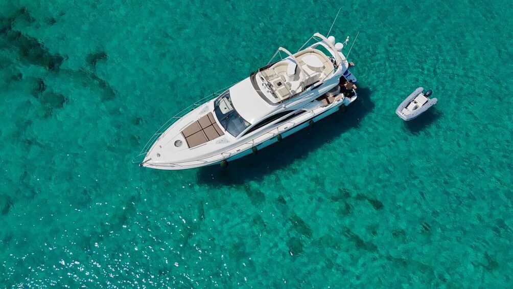 A white yacht anchored in clear turquoise waters. 1
