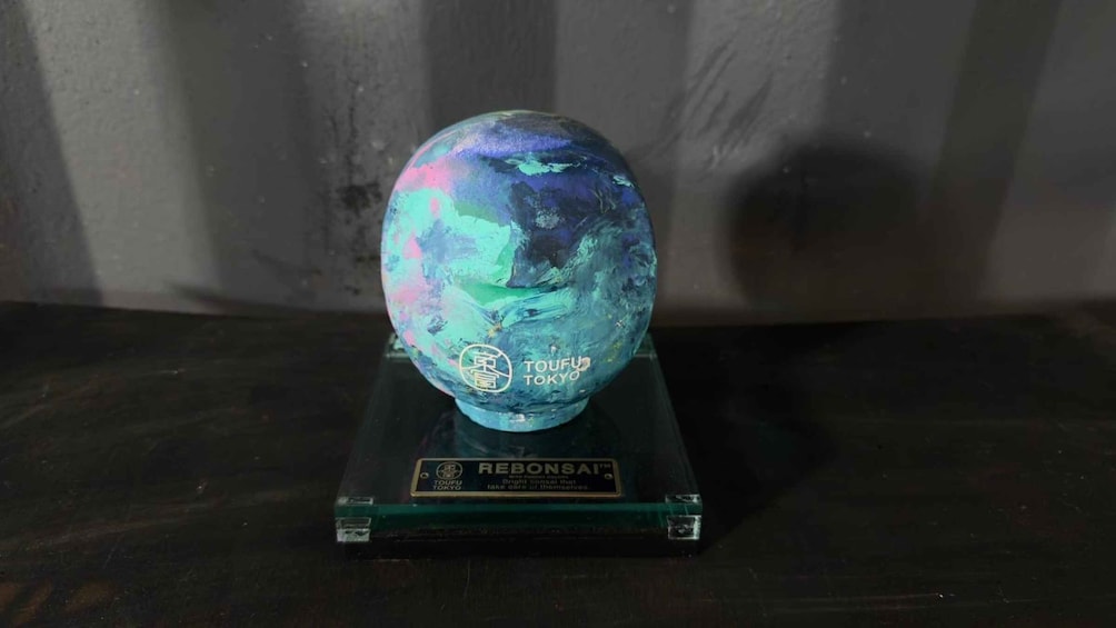 A globe on a glass stand with 'TOUFUTA TOKYO' and 'REBONSAI' labels. 4