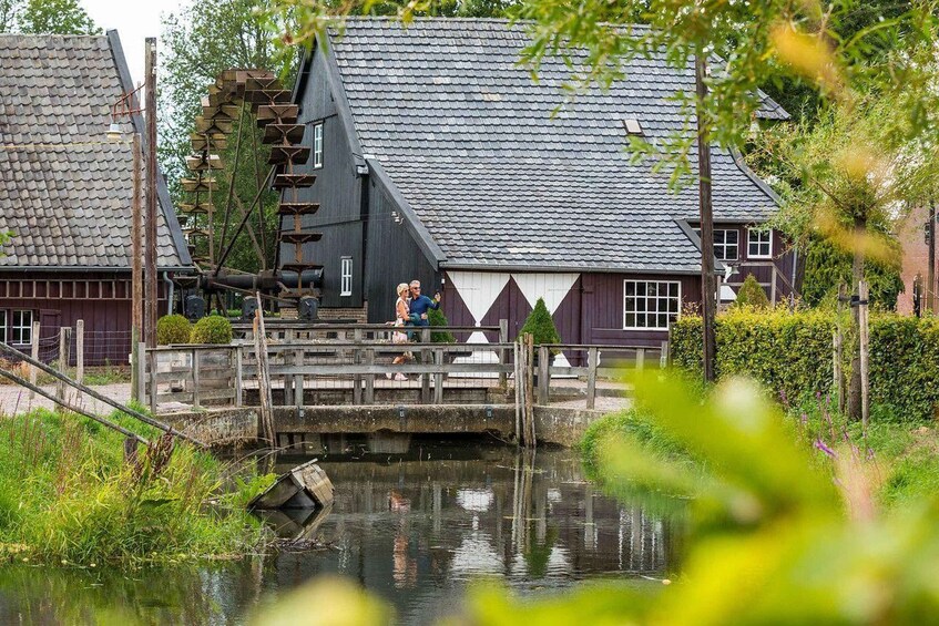 A wooden bridge over a canal with buildings in the background. 3
