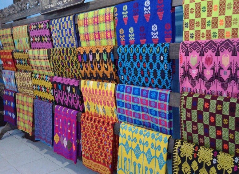 A variety of colorful textiles displayed on a wall. 4