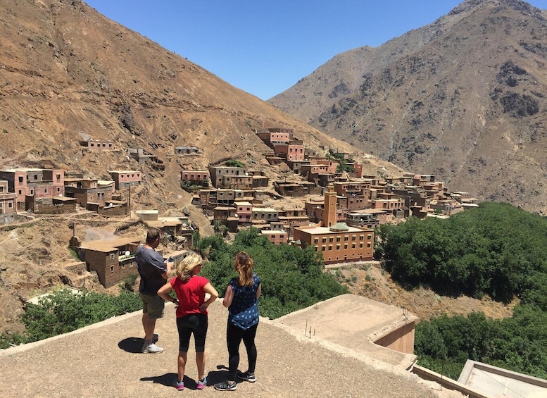 A mountainous village with terraced houses and a prominent minaret. 3