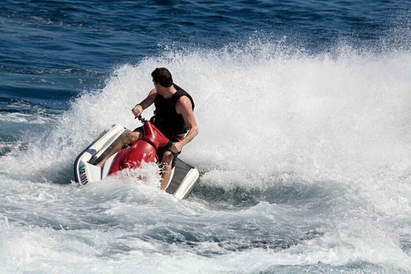 A person riding a jet ski on the water. 3