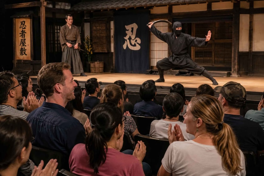 A martial arts performance with an audience watching. 4