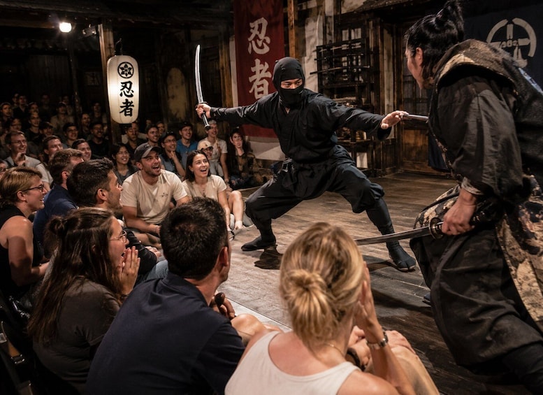 A martial arts performance with an audience watching. 3