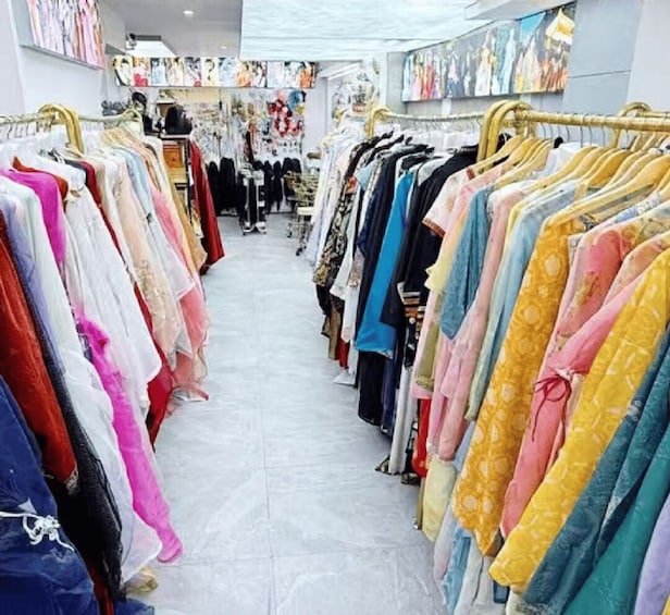 A clothing store with racks of colorful garments. 2
