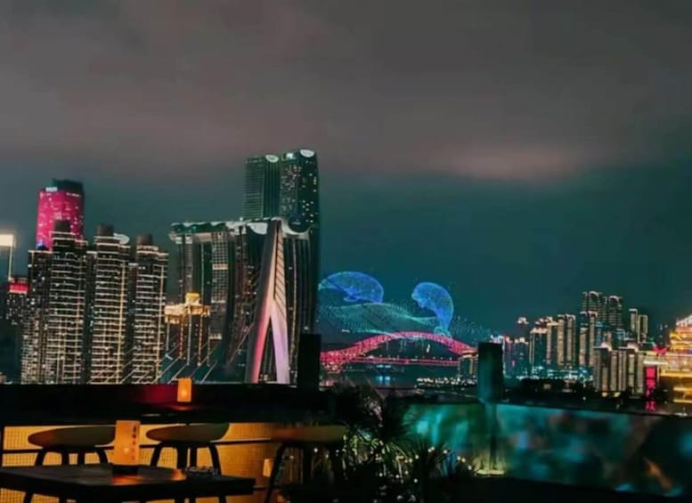 A city skyline at night with illuminated buildings and a bridge. 3
