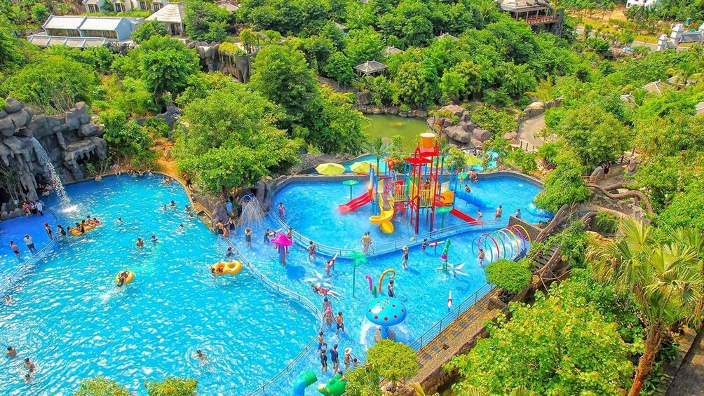 A water park with multiple pools, slides, and a jungle-themed environment. 5