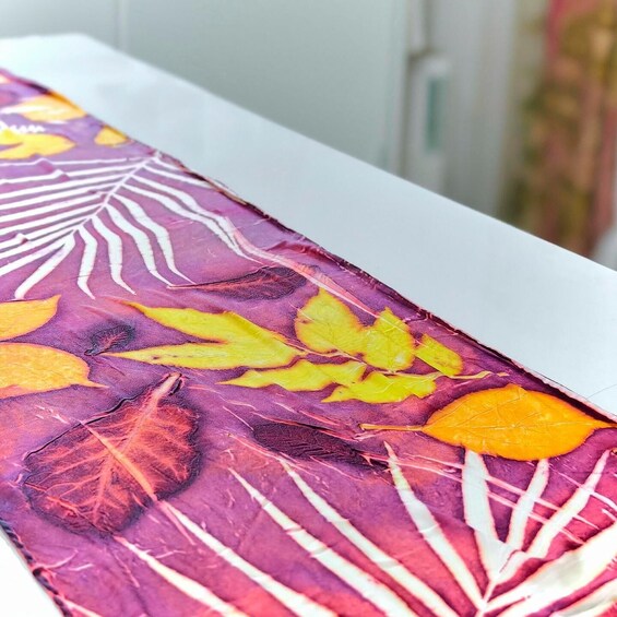 A table with a tablecloth featuring a leaf pattern. 1