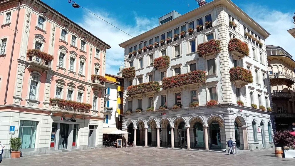 A historic building with ornate architecture and flower boxes on the balconies. 4
