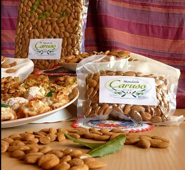 Various packaged almonds and a plate of almond-based food items. 3