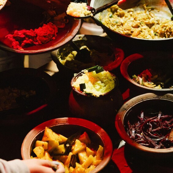 A variety of dishes in traditional clay pots, including what appears to be rice, vegetables, and possibly meat. 2
