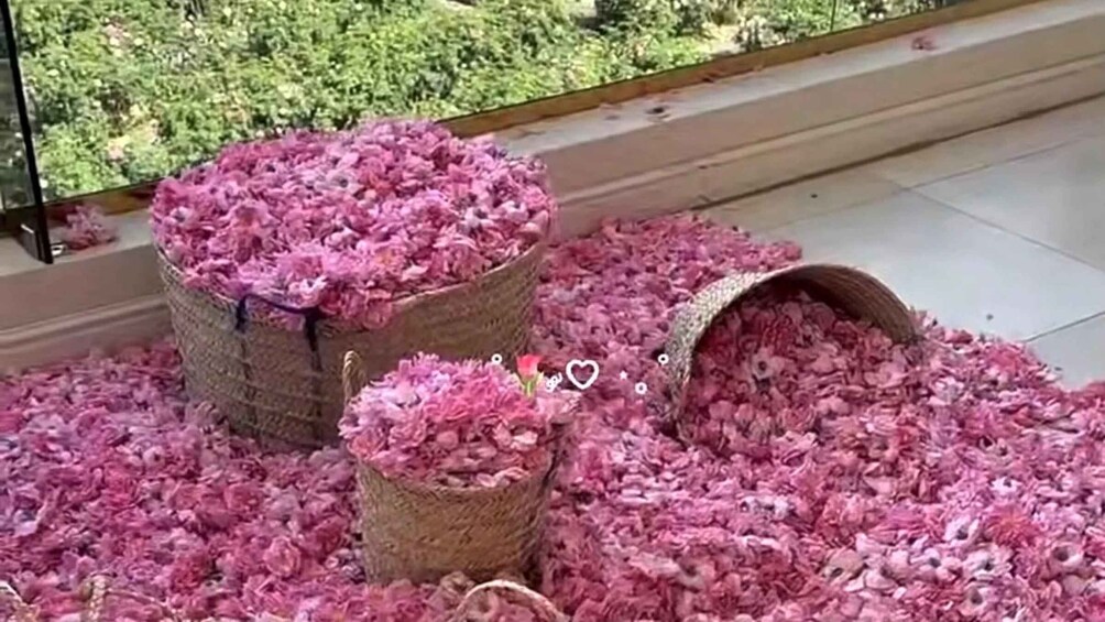 Two large woven baskets overflowing with pink shredded material, likely pet hair, on a tiled floor. 1