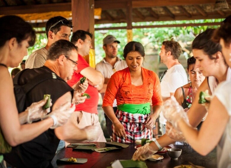 People preparing food outdoors under a shelter. 5