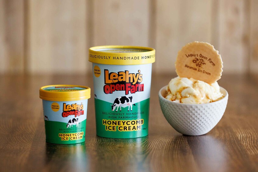 Two containers of Leahy's Open Farm honeycomb ice cream, one open in a bowl. 3