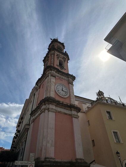 A clock tower with a weathered facade and a clear sky above. 5