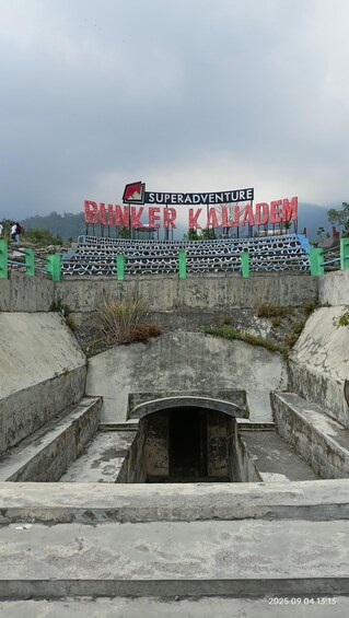 A sign for 'Superadventure Bunker Kaliajam' with a concrete structure and stairs leading down. 2