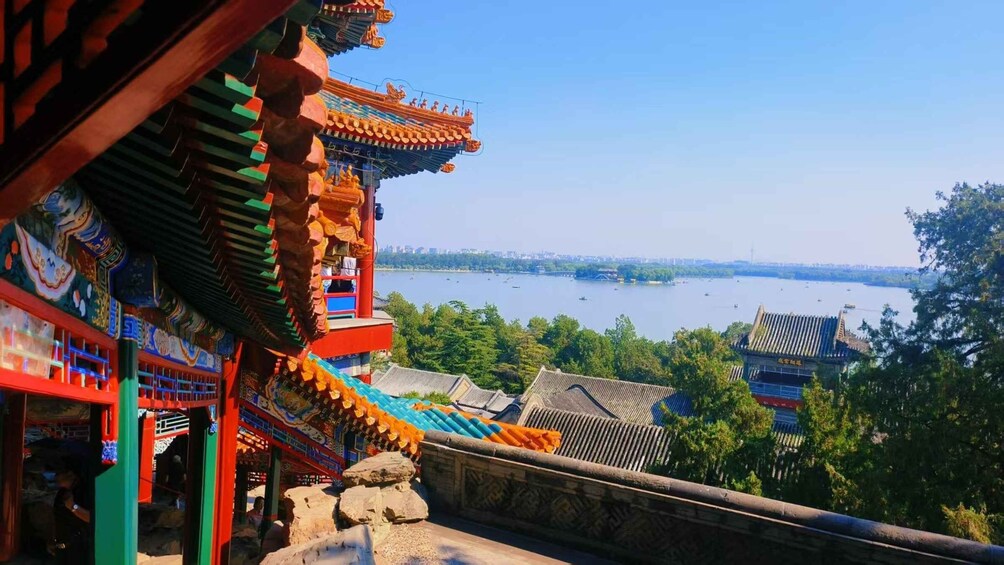 A traditional Chinese building with ornate architecture, a river, and boats in the background. 4