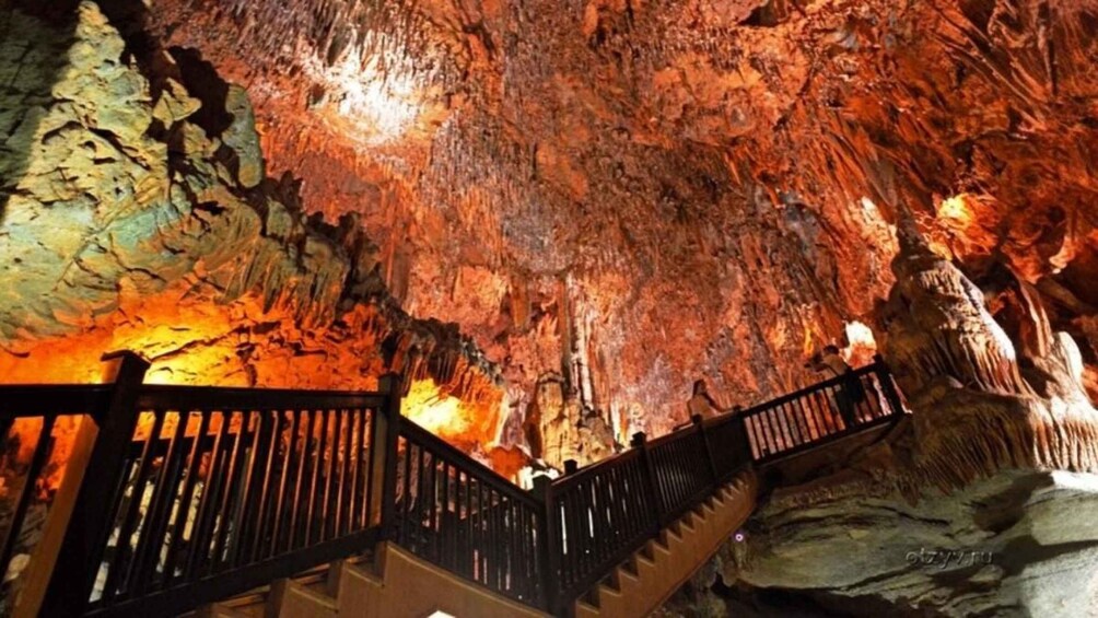 A cave with a wooden staircase and rocky walls. 2