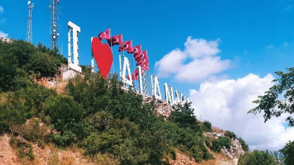 A hillside with a series of white structures and red flags. 5