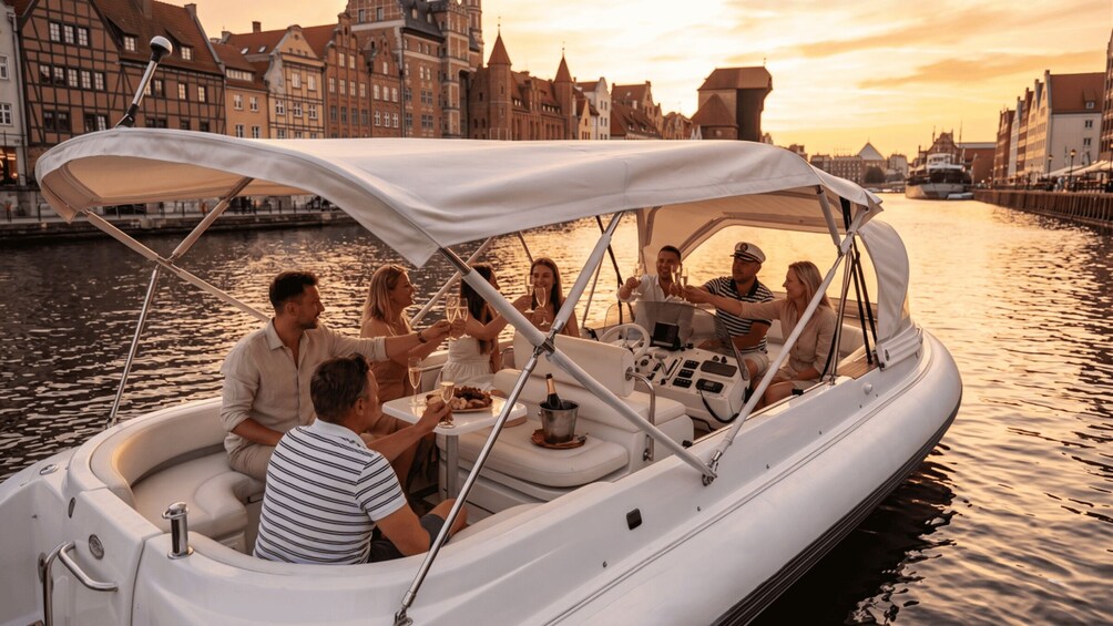 A group of people on a white boat with a canopy, enjoying drinks and conversation on a river with buildings in the background. 3