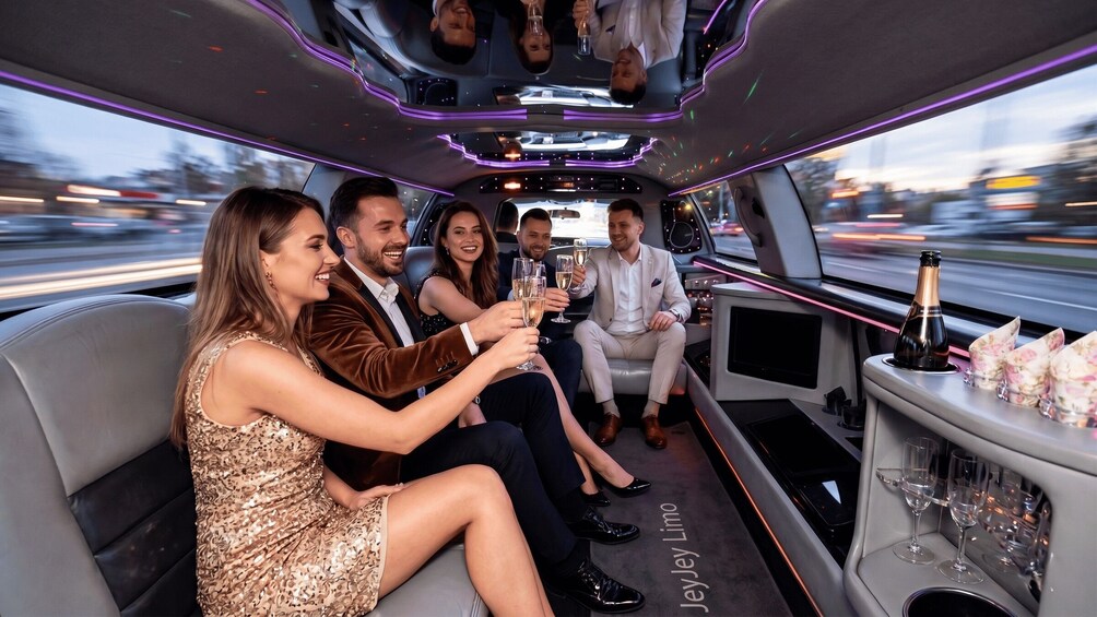 A group of people in a luxury car with champagne glasses, seated in the back. 2