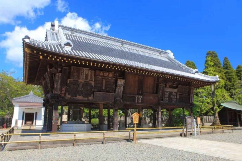 A traditional Japanese building with a tiled roof and wooden structure. 5
