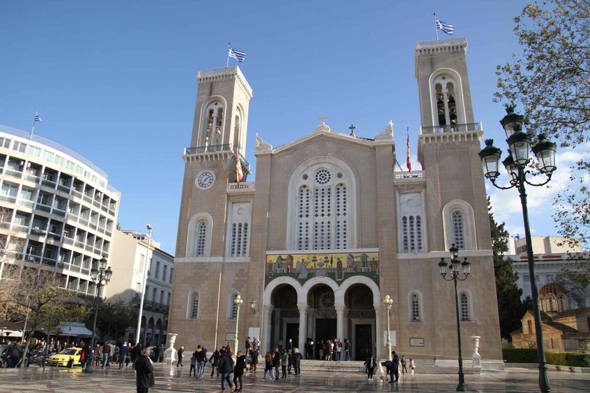A historic church with two towers, a large arched entrance, and a clock tower. 3