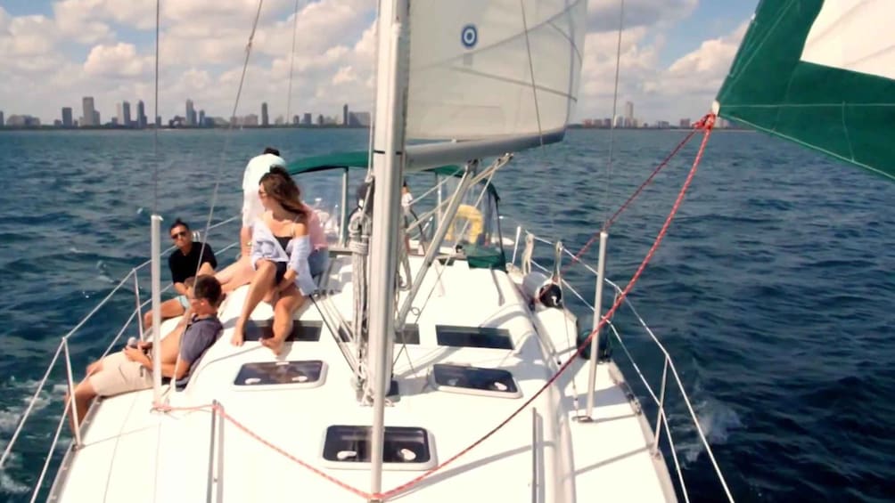A sailboat on water with a city skyline in the background. 3