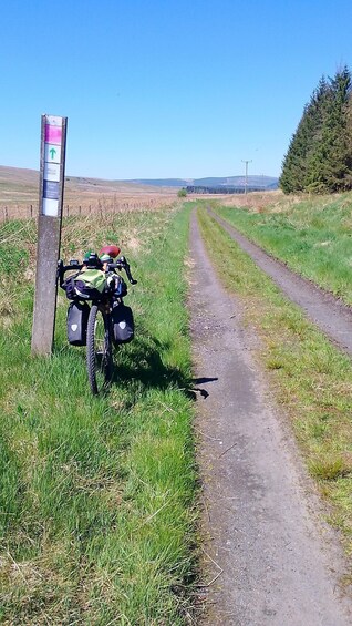 A dirt path with a signpost indicating the Bells Moor Shared Trail. 2