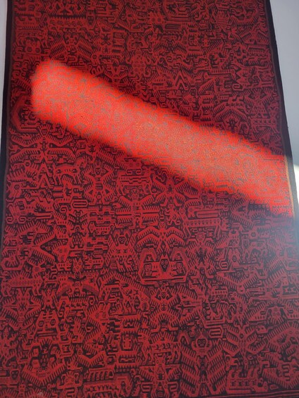 A red patterned fabric with intricate designs. 4