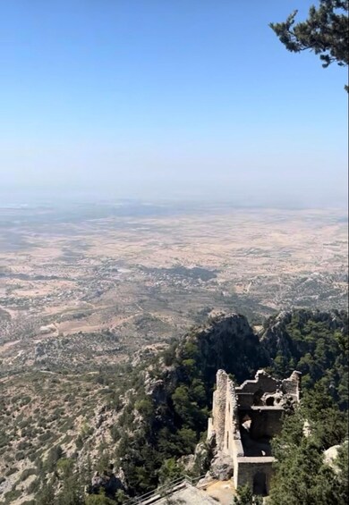 A mountainous landscape with a historical stone structure. 3