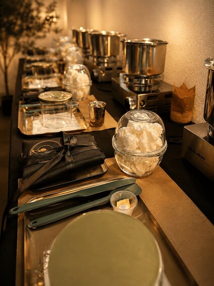 A buffet setup with various food containers and utensils. 2