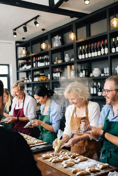A group of people in a bakery, preparing pastries. 2